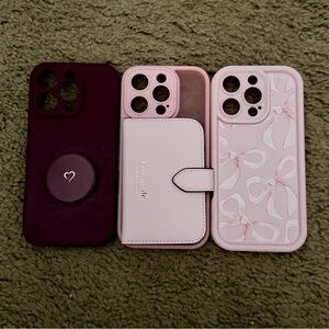 Three iPhone 16 pro Cases. Sheer pink, one with pink ribbons and deep red.